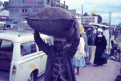 Street scene with porter and nun: Anjanahary, Antananarivo