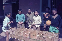 Kilasimandry [boarding] boys making a bamboo and brown paper model of the recently rebuilt girls' dormitory: Friends School, Soavinandriana